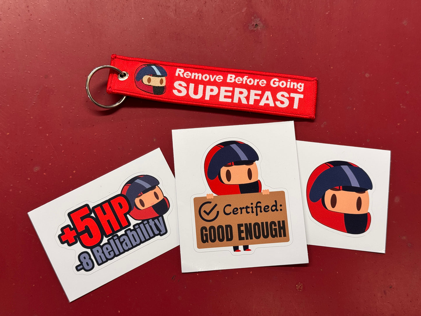 Keychain and stickers with cartoon character design on a red background