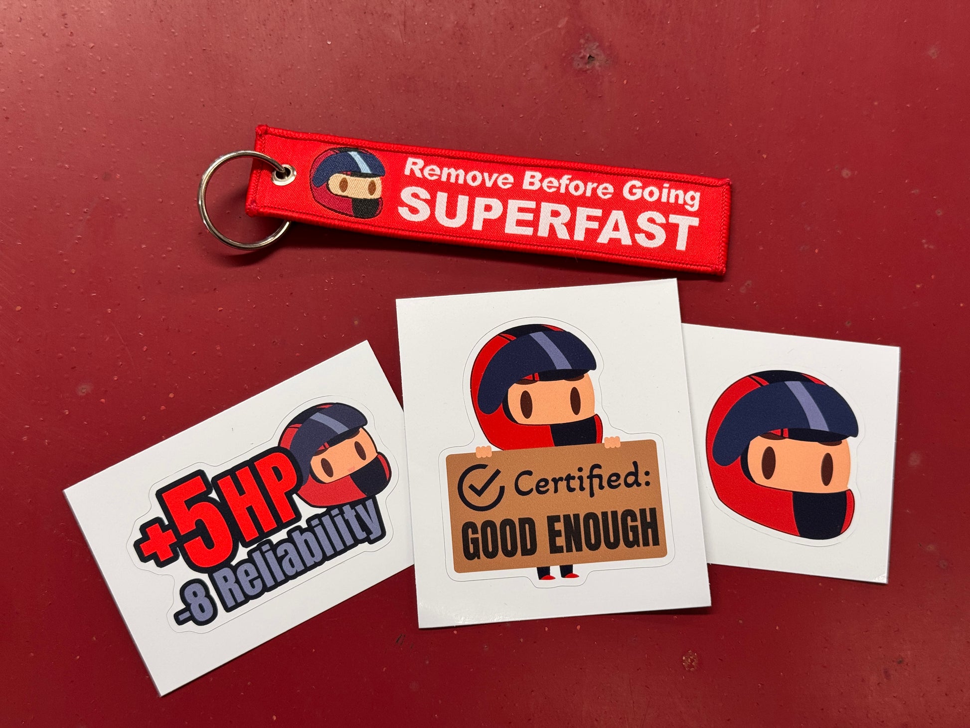 Keychain and stickers with cartoon character design on a red background